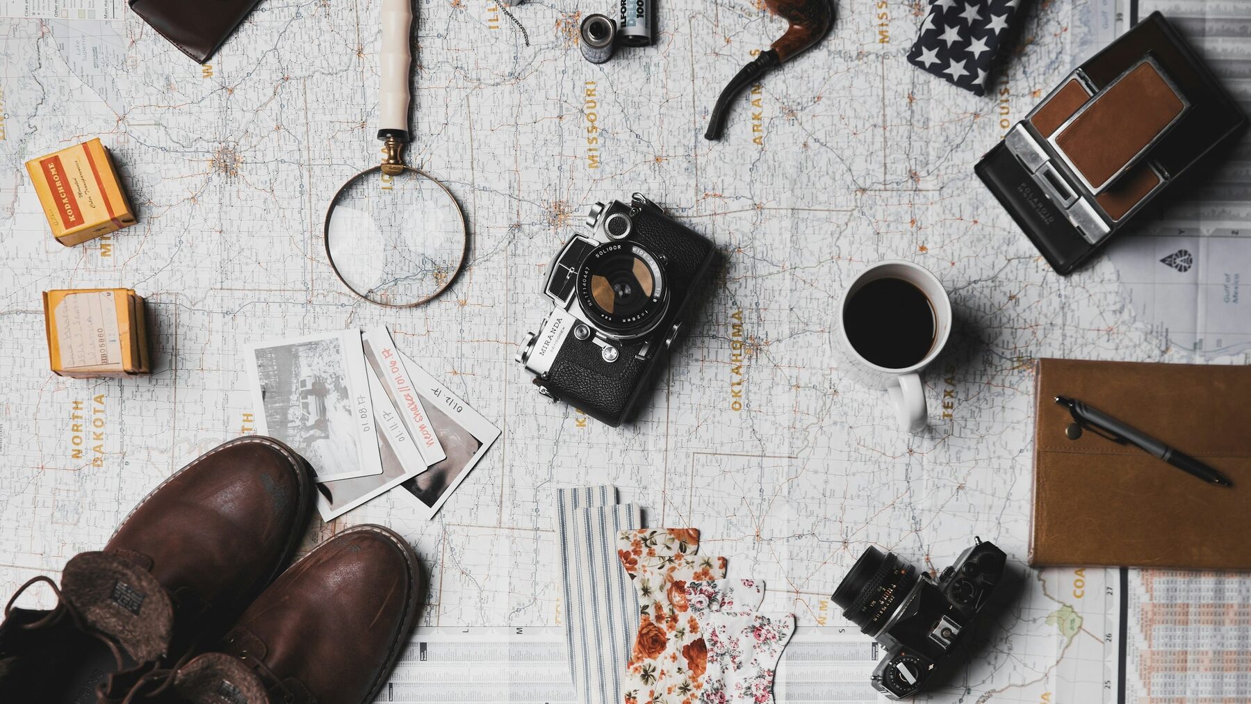 Travel flatlay with a jar, notebook and train ticket